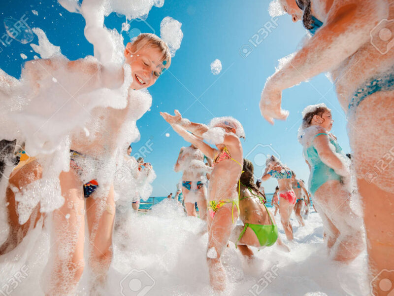 137505598-russia-tuapse-july-4-2019-foam-party-children-and-adults-have-fun-at-a-foam-party-on-the-beach-